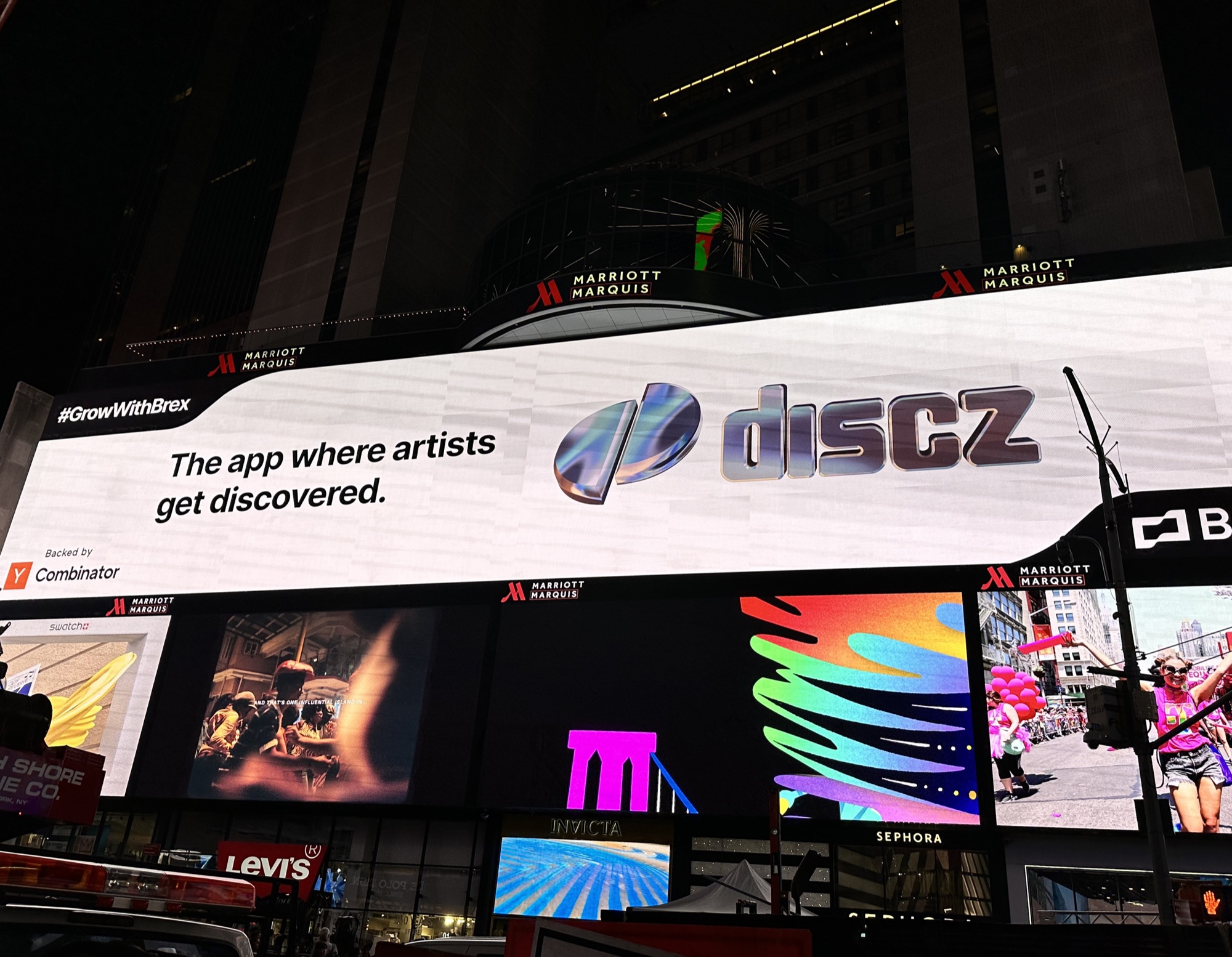 Discz billboard in Times Square — 'The app where artists get discovered', backed by Y Combinator
